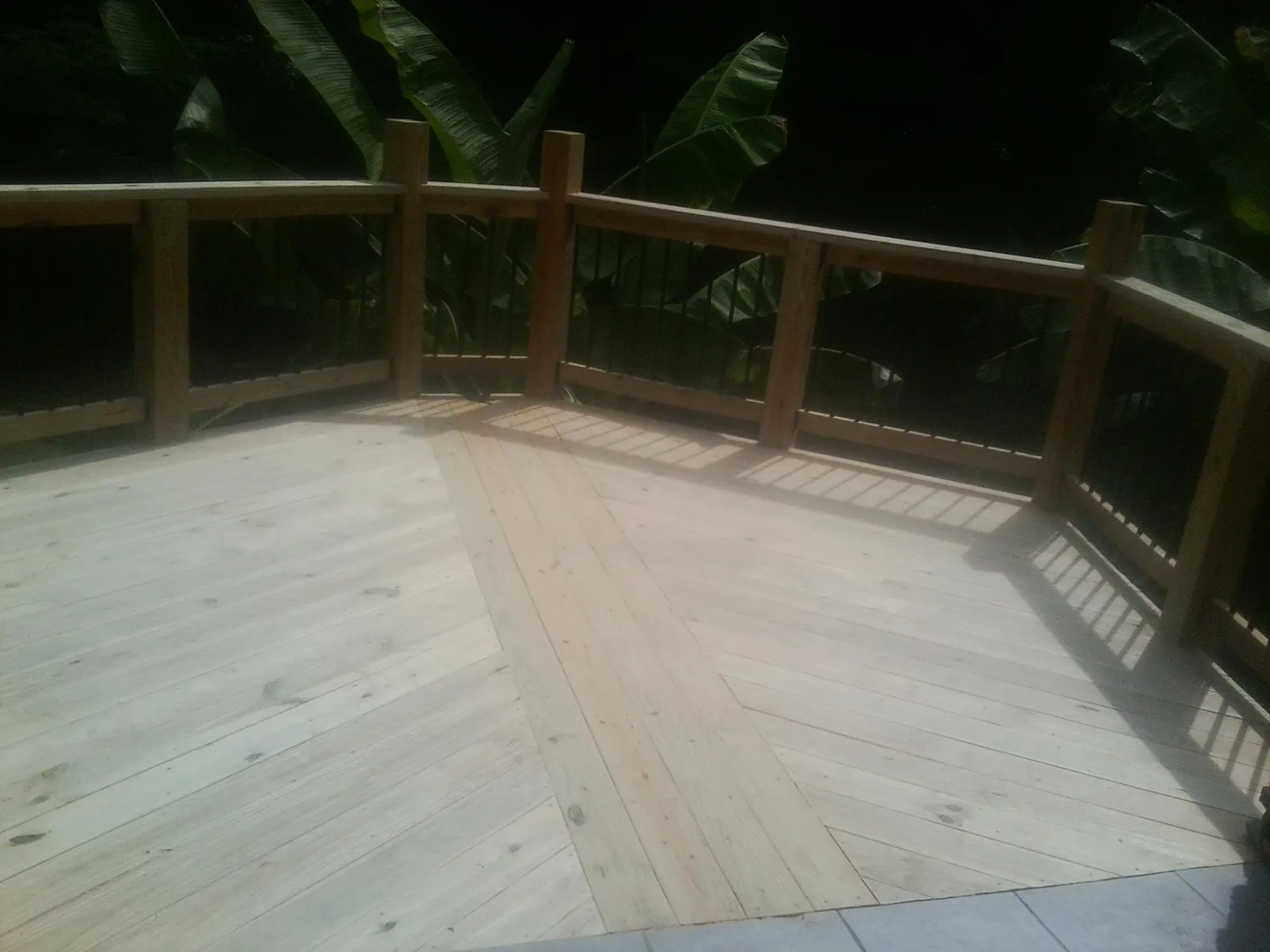 New wood deck and railing built off the back of a home in Massey